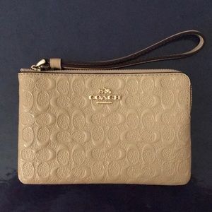 Tan color Coach wristlet